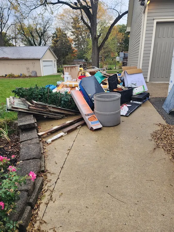 Dumpster being loaded with debris for Estate Cleanout Dumpster Rental in San Leandro